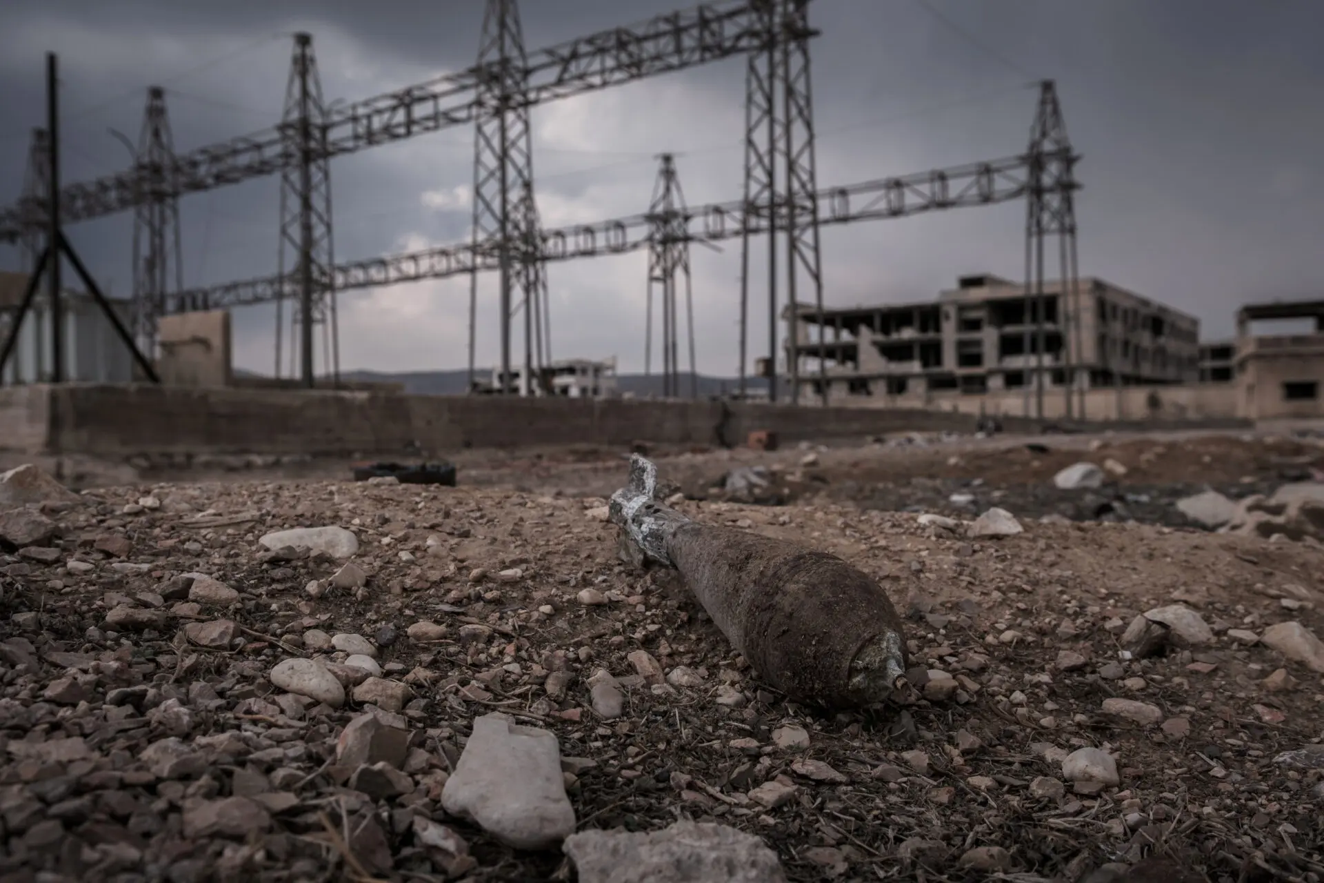 An unexploded mortar shell next to a destroyed power station in Qaboun. The manager at the only remaining power station in the area says only two out of eight of the transformers are operational.