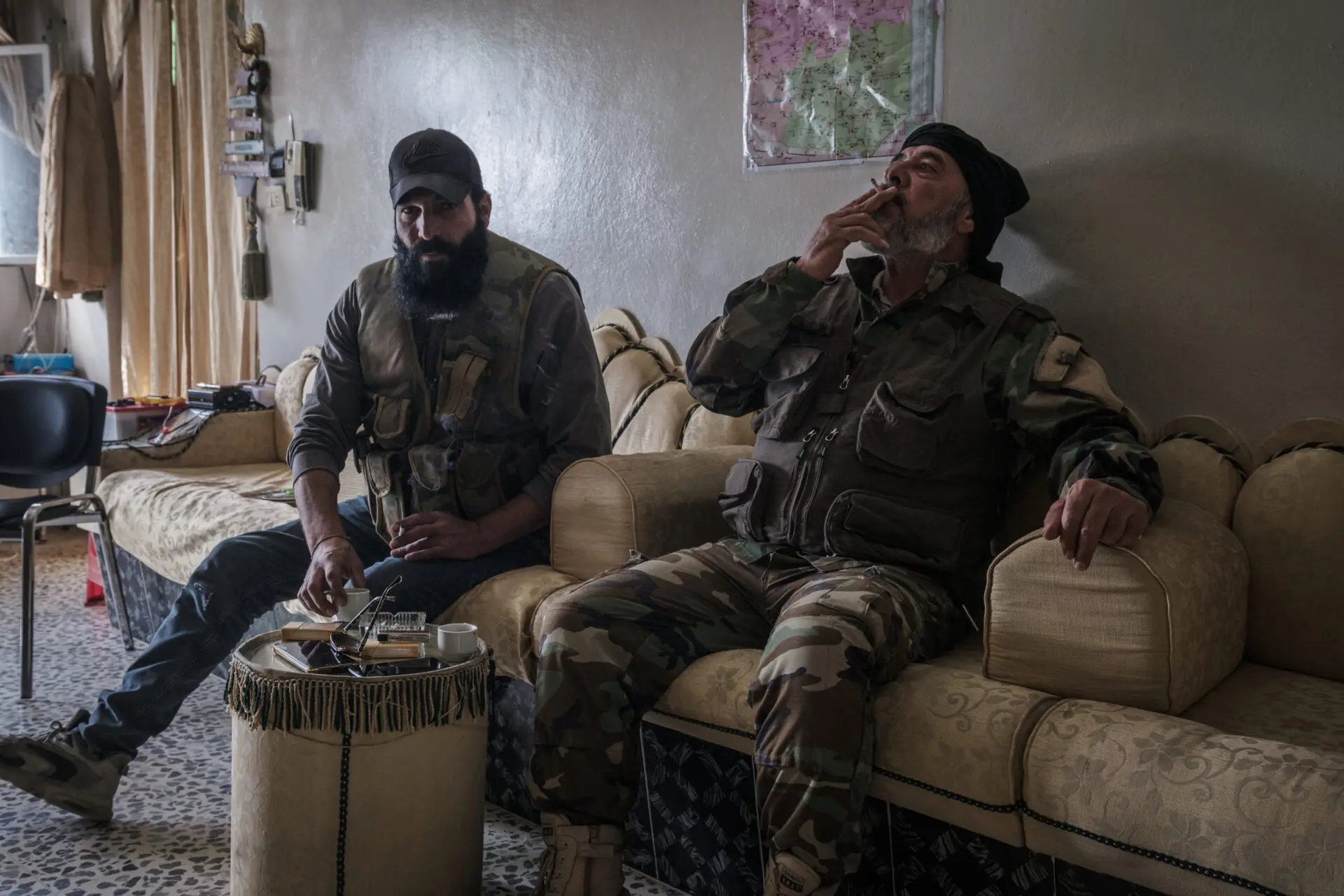 Alba (right) at a garrison in the outskirts of Sweida. ''We don't want our weapons, we love peace but they made us keep them because of the massacres that are happening in the coast''